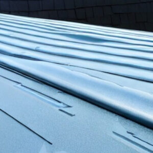 Spray-on type of commercial roofing on a blue roof