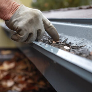 Clearing gutters as cautionary commercial roof maintenance